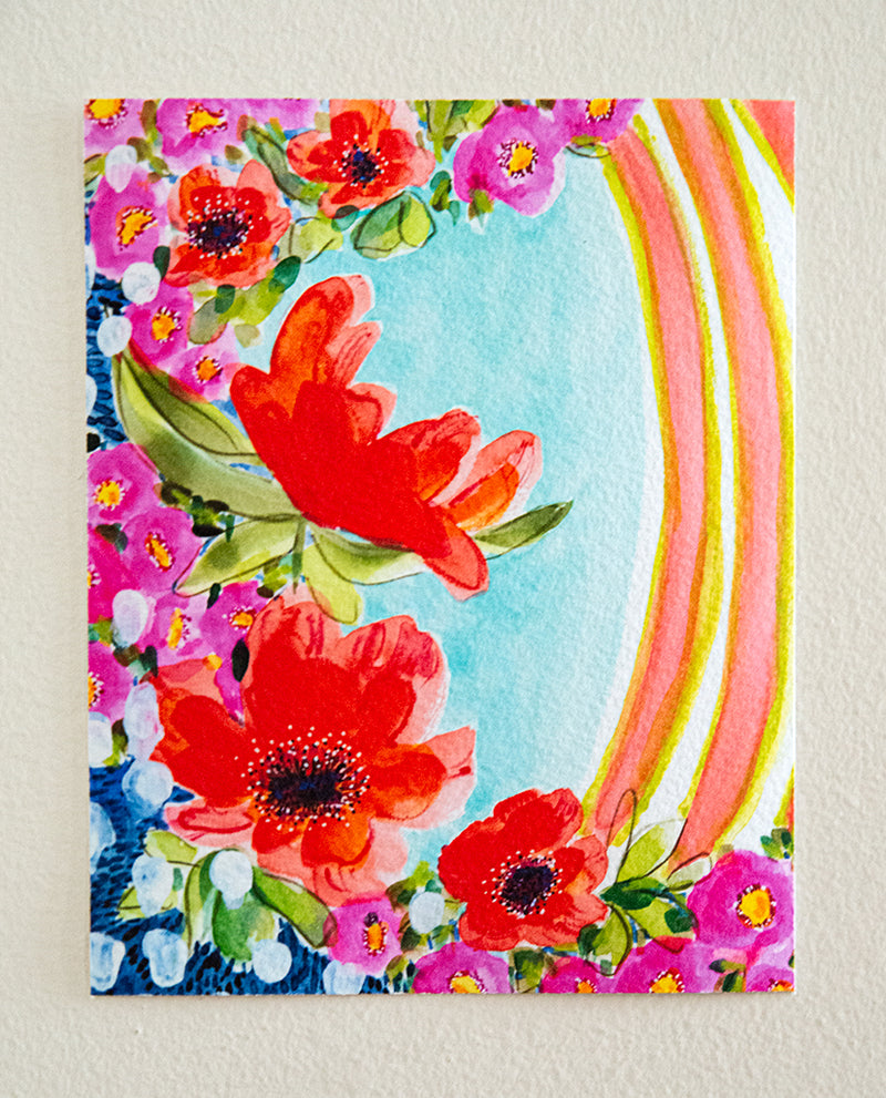 A vibrant watercolor mixed media fine art print featuring abstract floral elements in magenta, orange, and yellow with contrasting garden greens and sapphire blues, available as a fine art print or have it framed ready to hang.