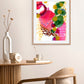 A vibrant abstract painting with bold strokes of red and gold, soft green and brown hues, displayed in a home setting with decorative items on the side.