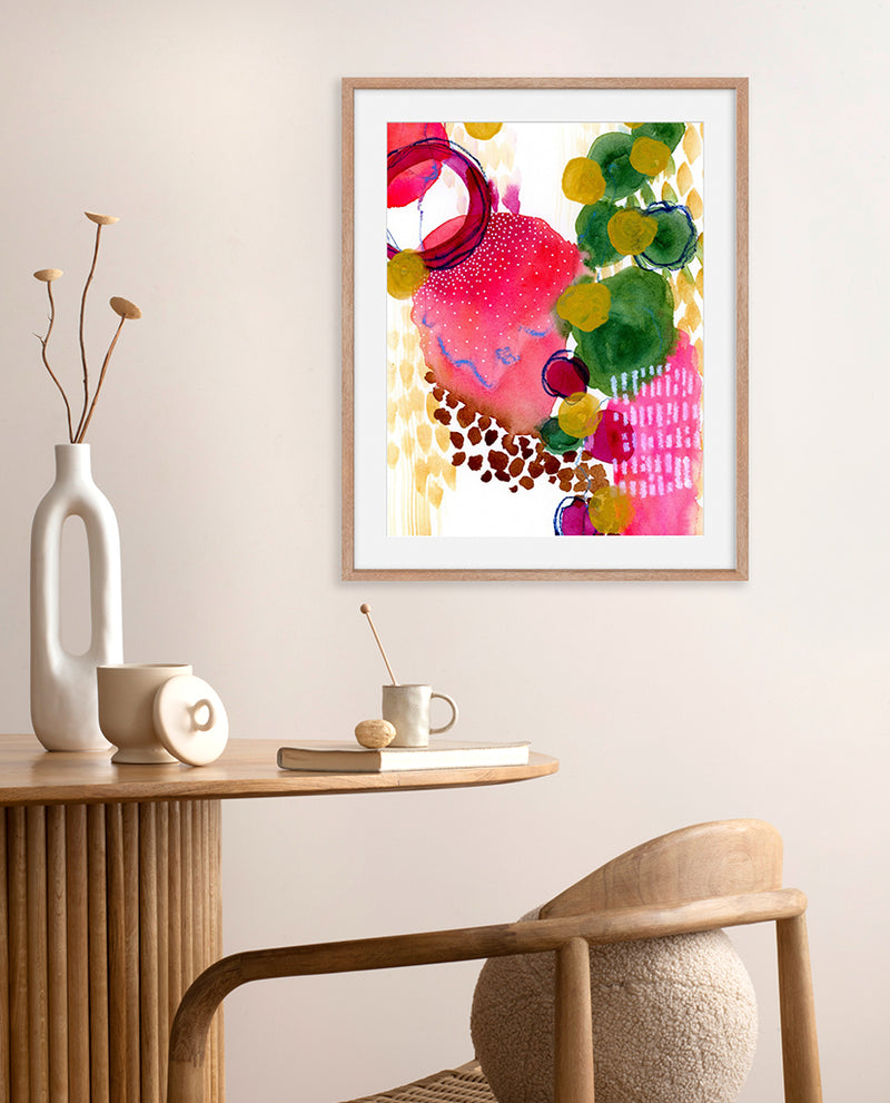 A vibrant abstract painting with bold strokes of red and gold, soft green and brown hues, displayed in a home setting with decorative items on the side.
