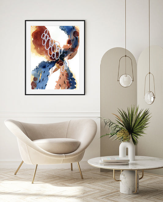 An abstract painting with flowing forms in burnt umbers, deep blues, white, and black, presented in a modern interior setting with a white armchair, wooden floor, and hanging lights.