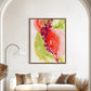 A abstract art print featuring swirling hues of rich crimson, soft limes, and delicate blush with white specks, displayed on a wall above a white sofa in a well-lit room.